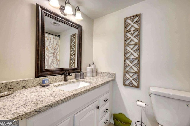 bathroom with vanity and toilet