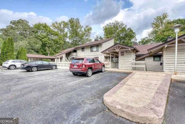 view of front of property with uncovered parking and a chimney