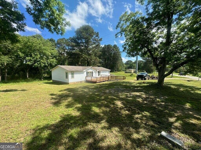 view of yard with a wooden deck