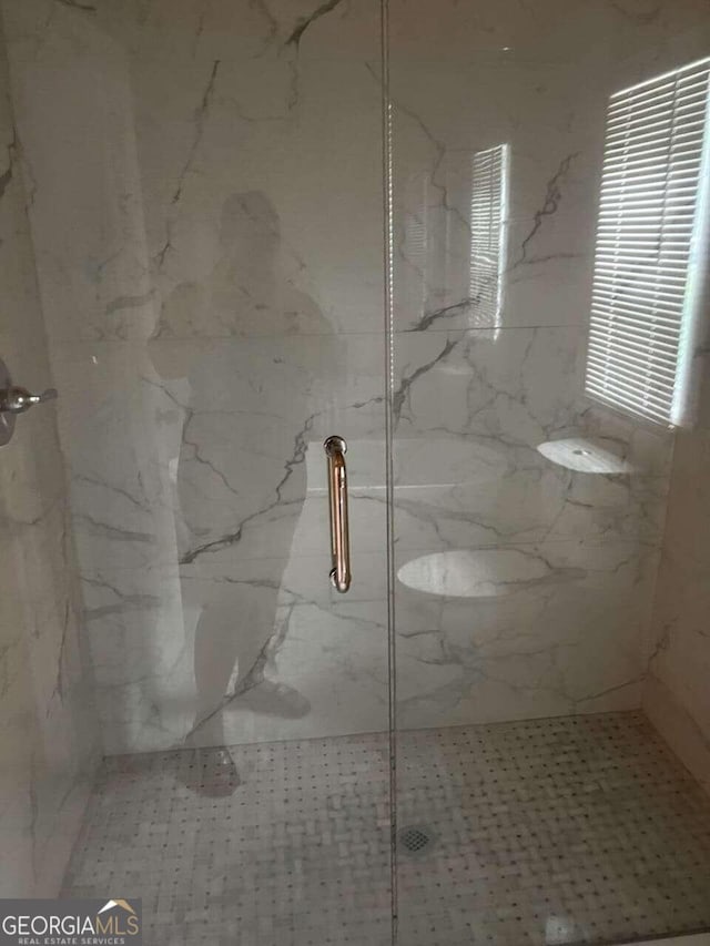 bathroom with a shower with shower door