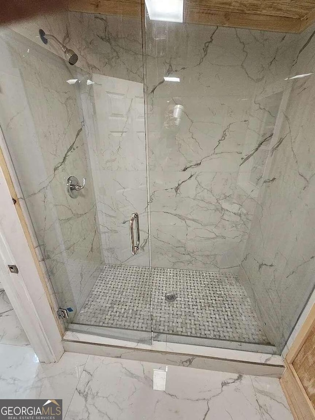 bathroom with a shower with door