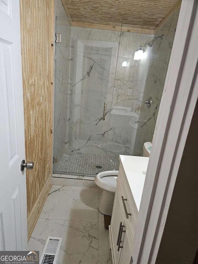 bathroom with walk in shower, vanity, and toilet