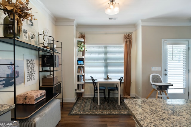 dining room with dark wood-type flooring and crown molding