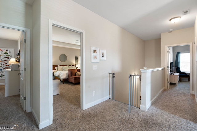 hallway with light colored carpet