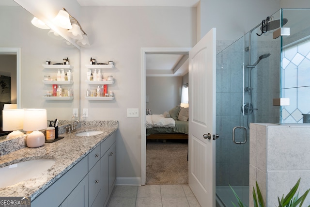 bathroom with tile patterned floors, a shower with shower door, and vanity