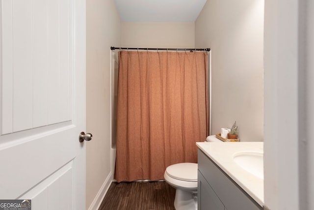 full bathroom featuring hardwood / wood-style floors, vanity, toilet, and shower / bath combo