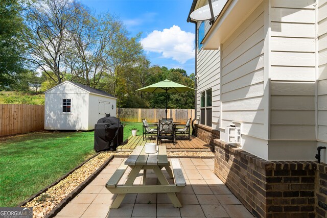 view of patio with a storage shed and area for grilling