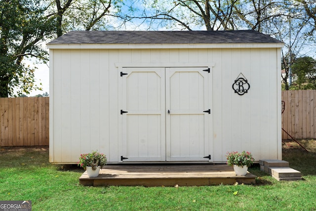 view of outbuilding featuring a lawn