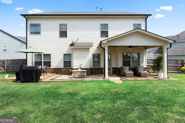 back of property featuring a lawn, outdoor lounge area, ceiling fan, and a patio