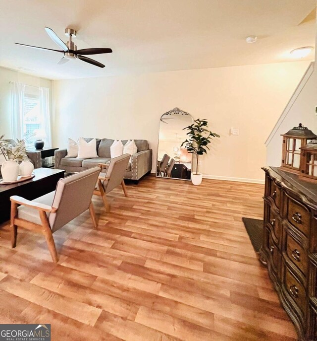 living room featuring ceiling fan and light hardwood / wood-style floors