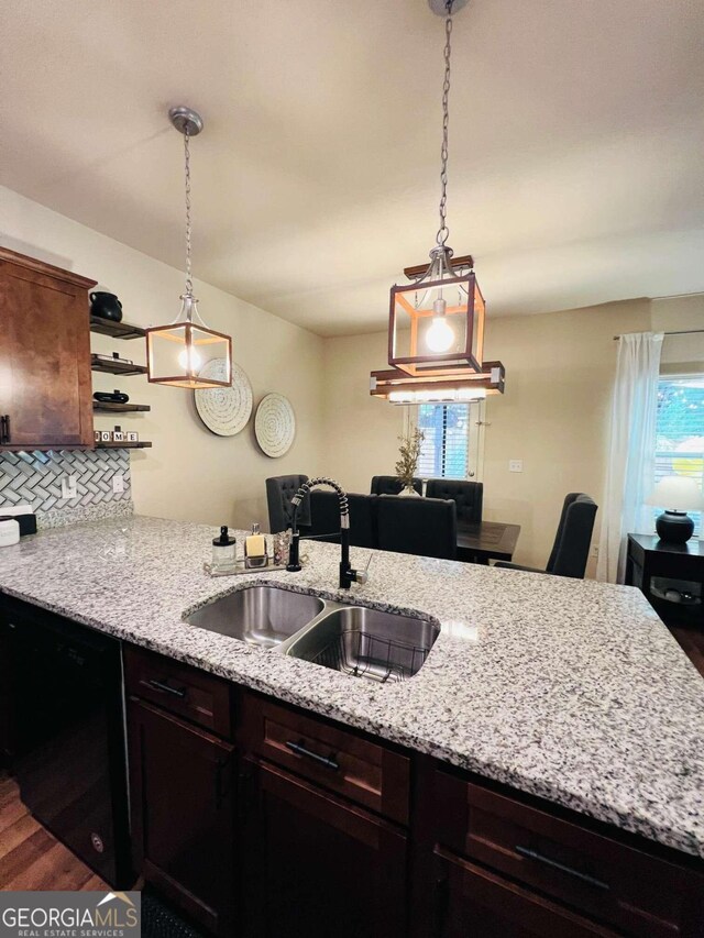 kitchen with backsplash, dishwasher, wood-type flooring, decorative light fixtures, and sink