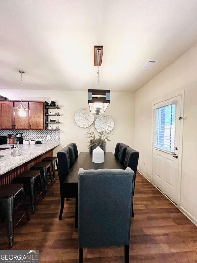 dining space featuring dark hardwood / wood-style flooring