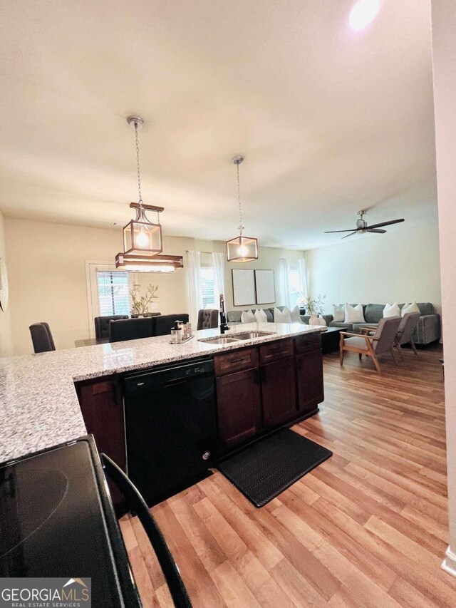 kitchen with pendant lighting, dishwasher, light hardwood / wood-style floors, light stone countertops, and ceiling fan