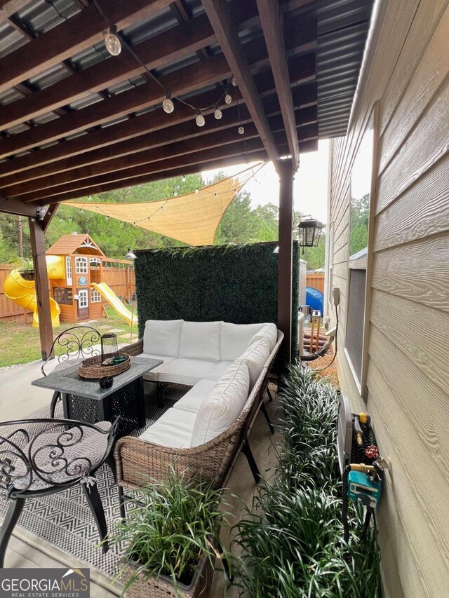 view of patio / terrace with outdoor lounge area and a storage unit