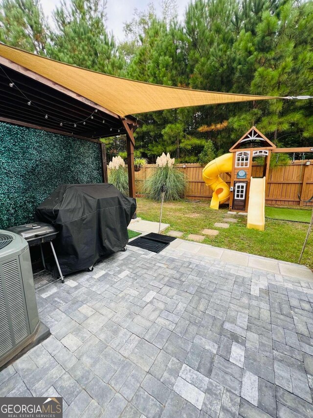 view of patio with a playground, area for grilling, a gazebo, and central air condition unit