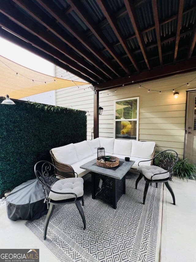 view of patio / terrace featuring an outdoor living space with a fire pit