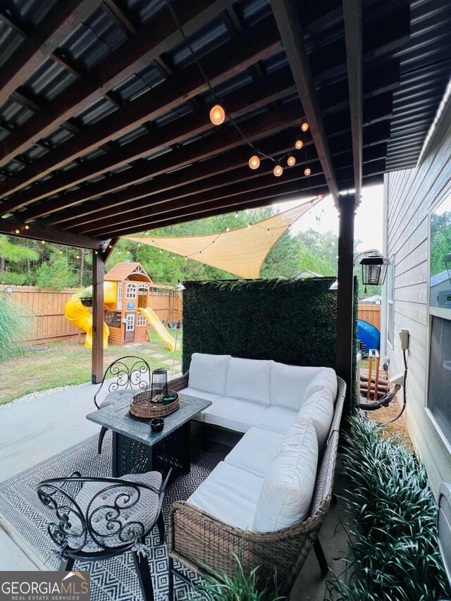 view of patio with an outdoor living space and a playground