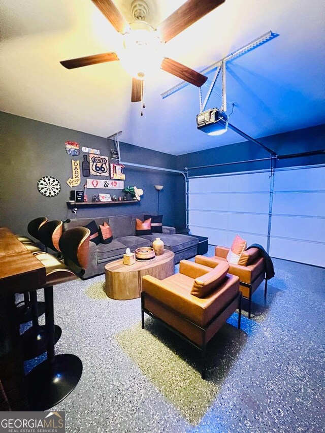 interior space featuring a garage door opener and ceiling fan