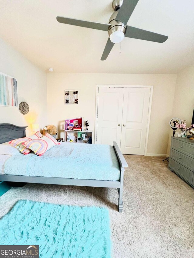 carpeted bedroom with a closet and ceiling fan