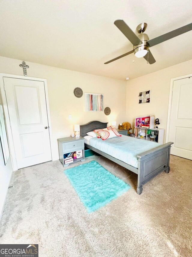 bedroom with ceiling fan and carpet