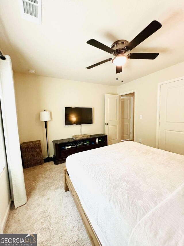 carpeted bedroom with ceiling fan