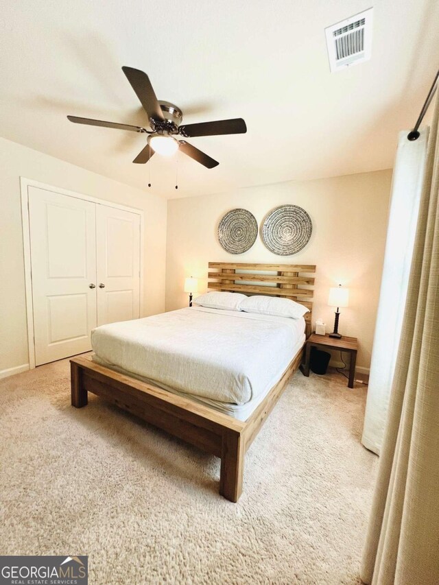 bedroom with ceiling fan, a closet, and carpet flooring