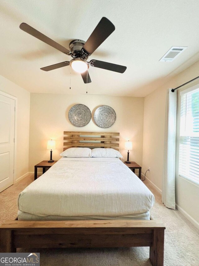 carpeted bedroom with ceiling fan