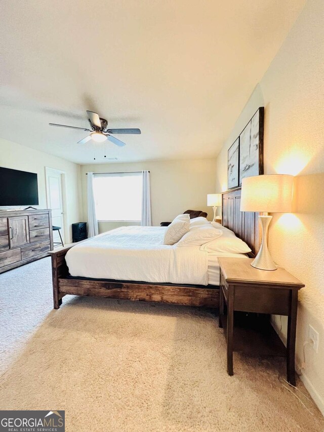 carpeted bedroom with ceiling fan