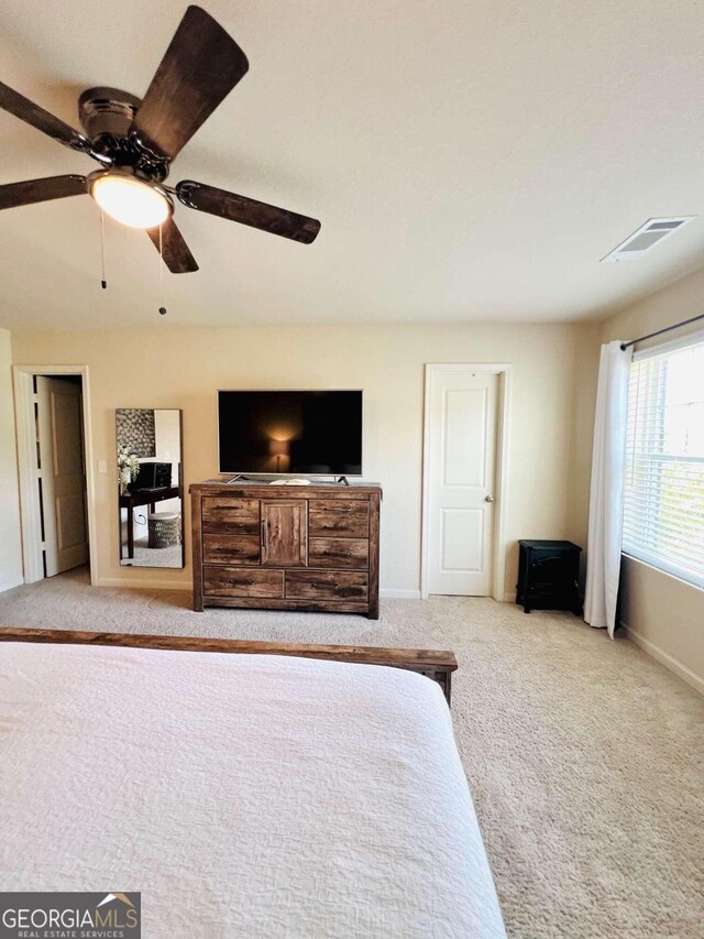 bedroom featuring ceiling fan and light colored carpet