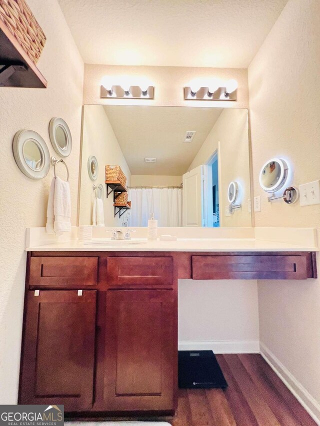 bathroom featuring vanity and hardwood / wood-style floors