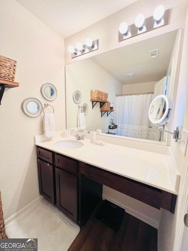 bathroom featuring vanity and a shower with curtain