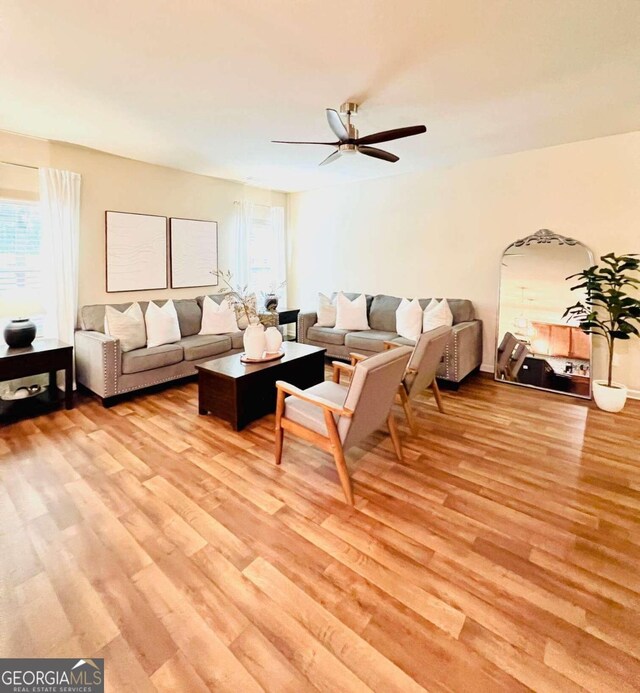 living room featuring ceiling fan and light wood-type flooring