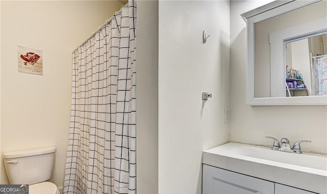 bathroom with vanity, toilet, and a shower with shower curtain