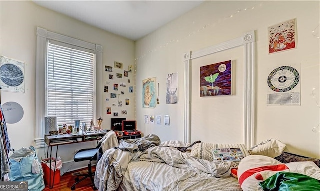 bedroom with hardwood / wood-style floors and multiple windows