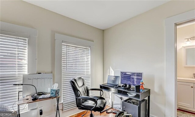 1313 Whitaker St, Savannah, GA 31401 - home office featuring plenty of natural light and baseboards