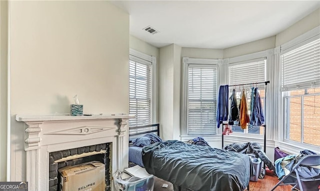 bedroom featuring hardwood / wood-style flooring and multiple windows