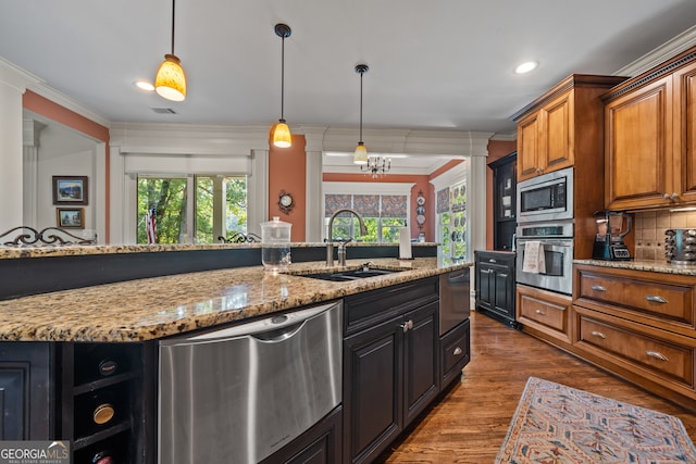 kitchen featuring appliances with stainless steel finishes, crown molding, and a healthy amount of sunlight