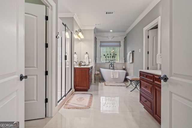 bathroom featuring vanity, ornamental molding, and a bathtub