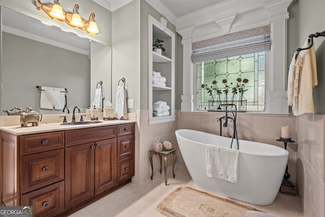 bathroom with vanity, a tub, tile patterned floors, and tile walls