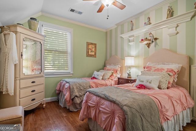 bedroom with dark hardwood / wood-style flooring, lofted ceiling, crown molding, and ceiling fan