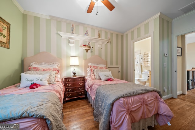 bedroom with ceiling fan, wood-type flooring, ensuite bathroom, and ornamental molding