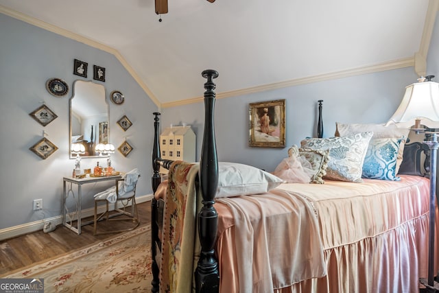 bedroom featuring lofted ceiling, hardwood / wood-style floors, ornamental molding, and ceiling fan