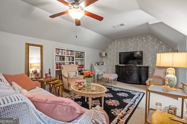 living room featuring built in shelves, vaulted ceiling, carpet floors, and ceiling fan