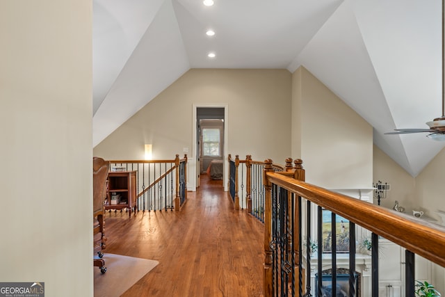 corridor featuring lofted ceiling and hardwood / wood-style floors