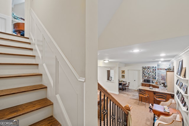 staircase featuring crown molding