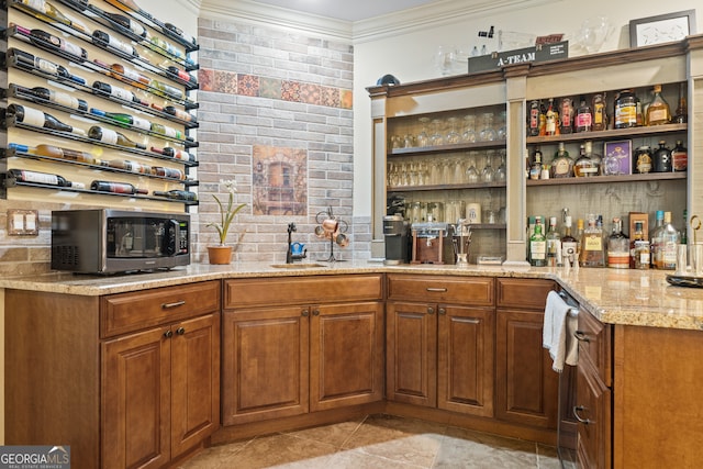 bar featuring light stone countertops, ornamental molding, and light tile patterned floors