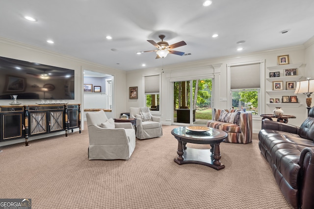 living room with ornamental molding, light carpet, and ceiling fan