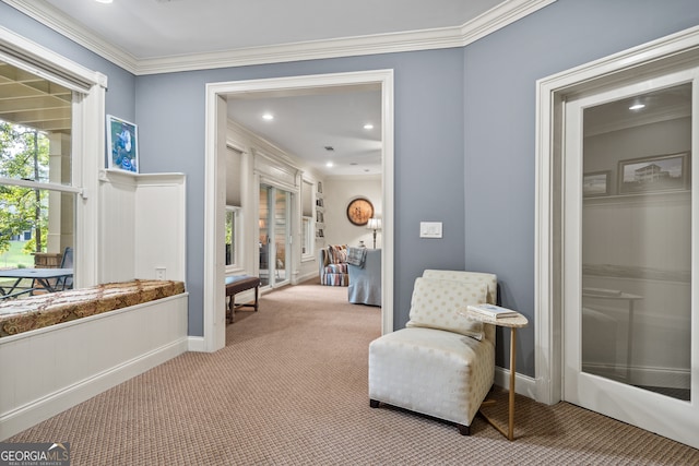 sitting room with light carpet and crown molding