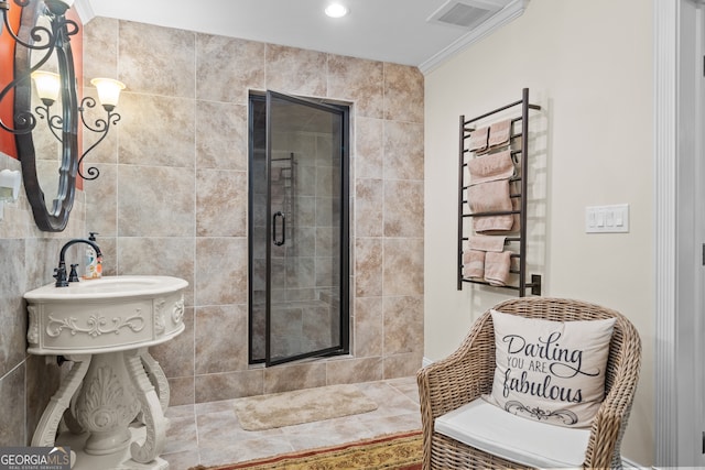 bathroom featuring ornamental molding, an enclosed shower, and tile walls