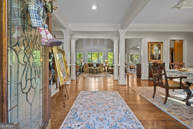 foyer entrance with crown molding and hardwood / wood-style flooring